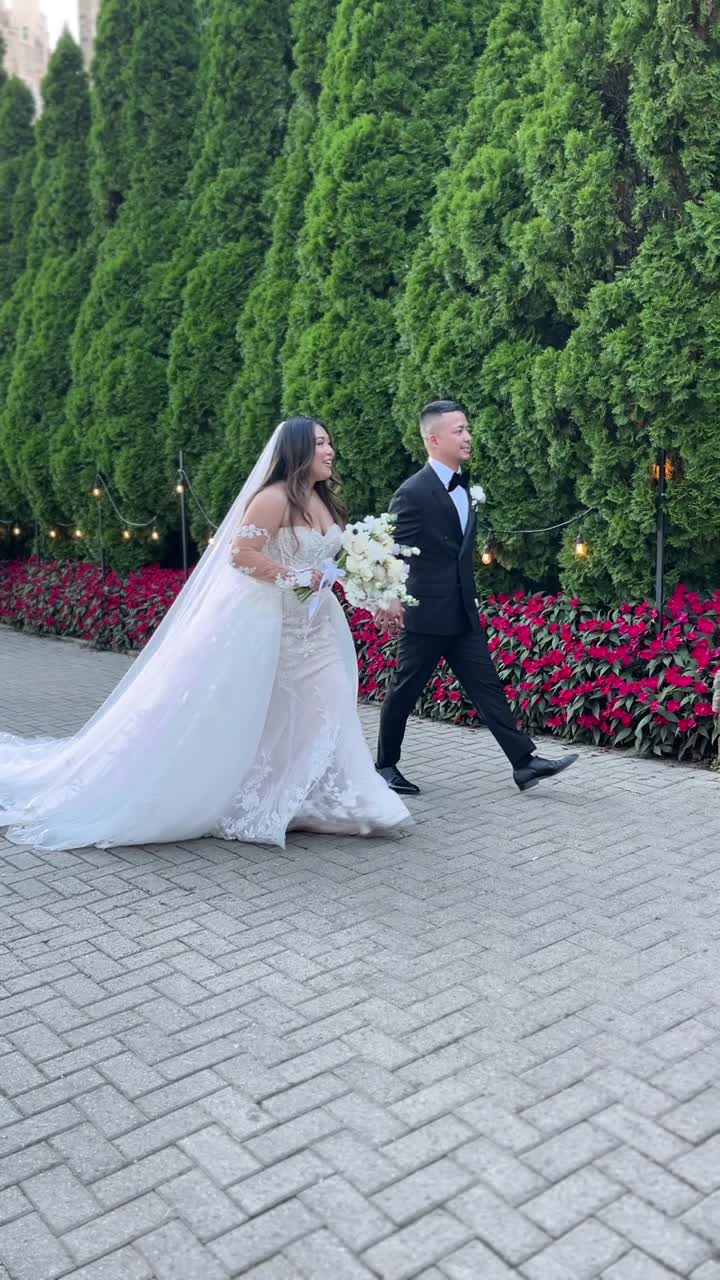 Shea and Zain walking along a garden path at Casa Loma